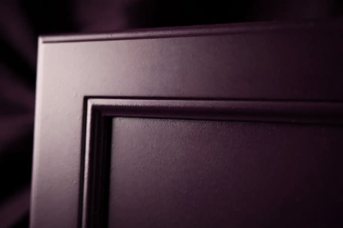 Close-up of a sprayed shaker cabinet door with a flawless satin finish